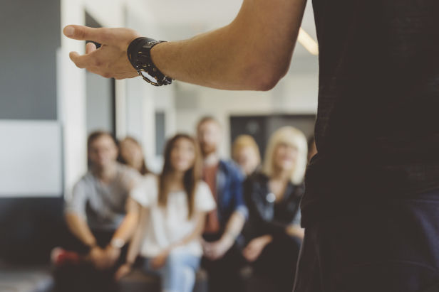 person_speaking_in_front_of_group